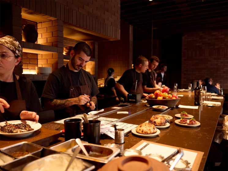 Chef Sertac Dirik and team members working at counter during service at Kid restaurant in Soho