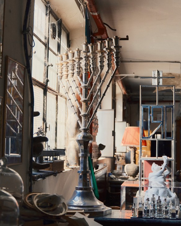 Silver candlestick and vessels displayed at Pampaloni workshop in Florence.