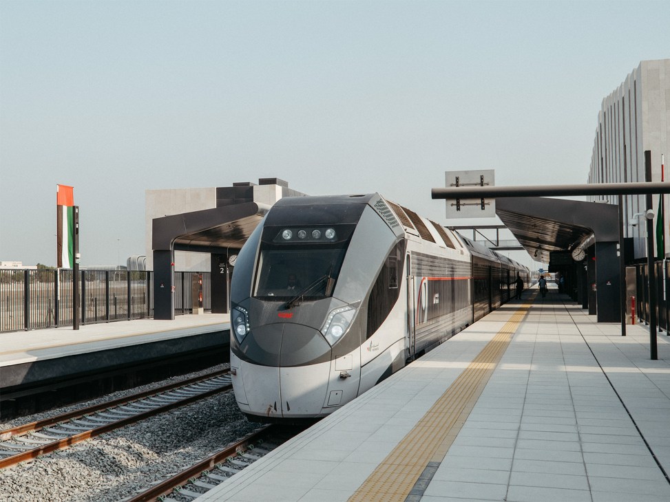 Modern Etihad Rail passenger train at Mohamed bin Zayed City station platform in Abu Dhabi.