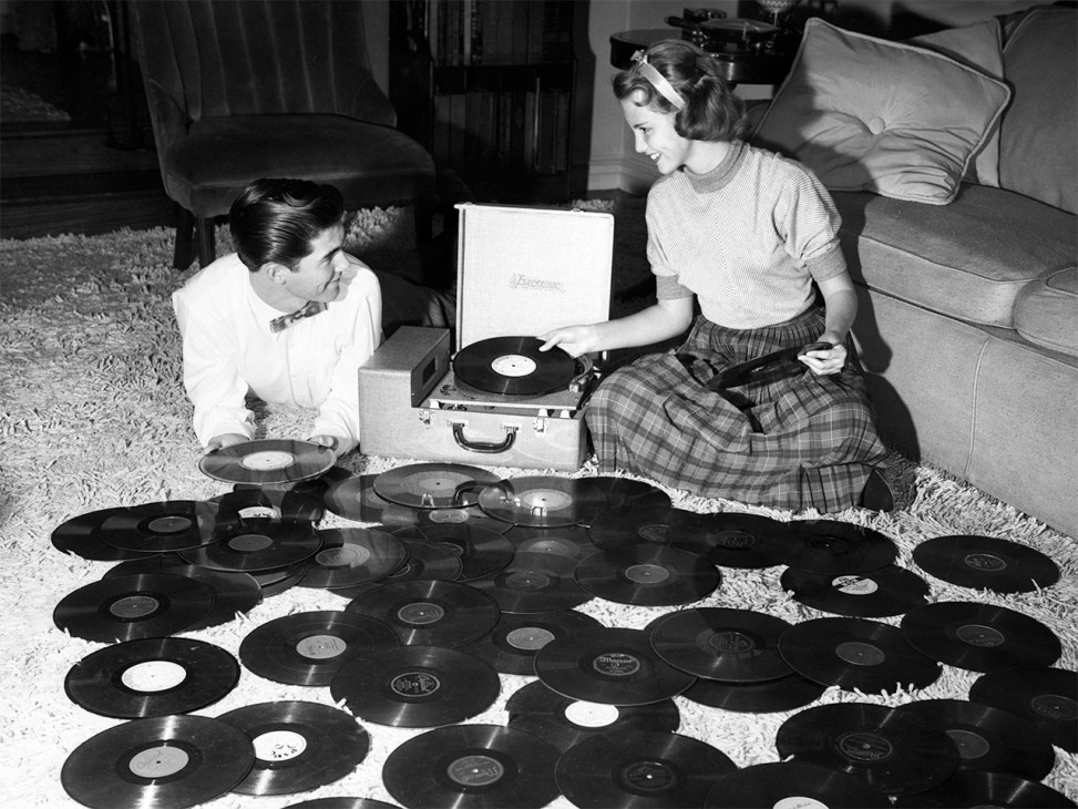 women surrounded by vinyl records