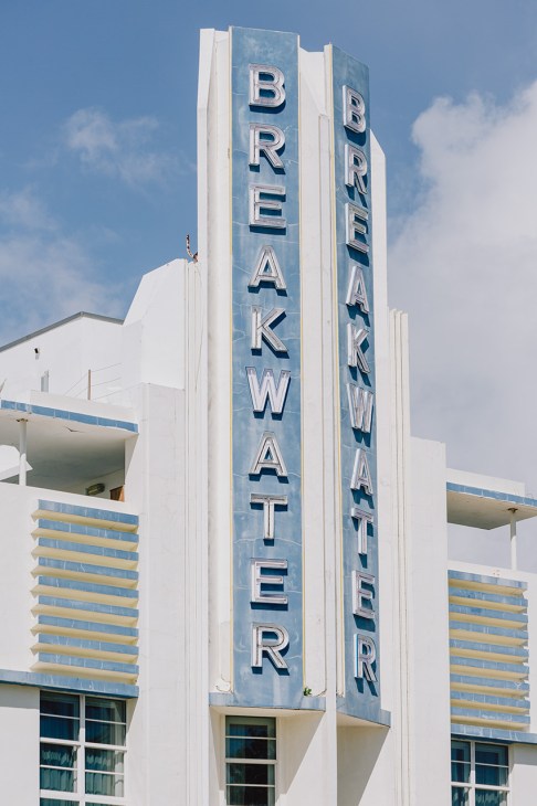 Tiffany Hotel art deco sign with chrome lettering on blue and white facade in Miami Beach