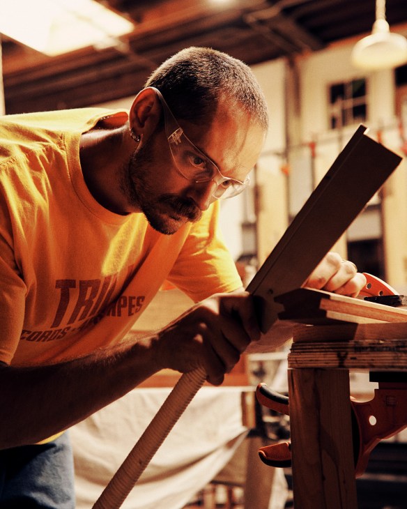 Furniture maker Free Alexander Tripp working on wood at Piscina workshop.