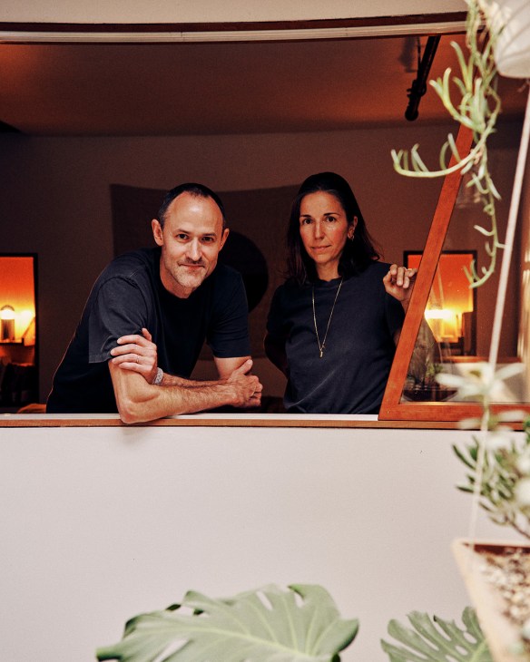 Architect Wes Rozen and furniture-maker Natalie Shook pose together at a window in their Red Hook home.