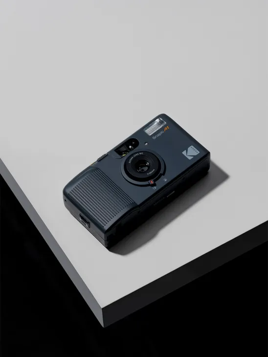 Kodak Snapic A1 35mm film camera with dark blue body and textured grip on white surface