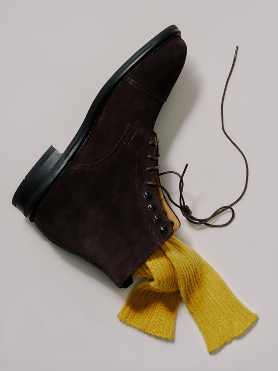 Dark brown suede lace-up boot with black sole and yellow ribbed socks by Morjas and Paris Socks.