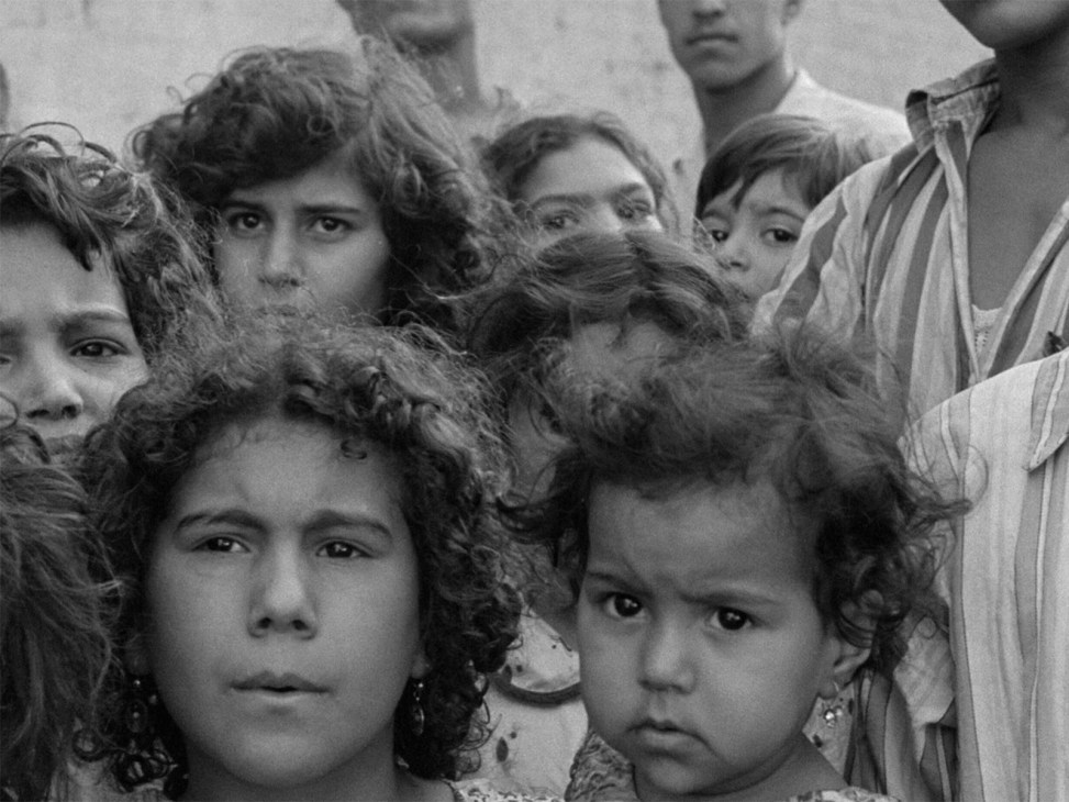 Black and white still from 1957 film 'Said Effendi' showing a group of people including children with intense expressions.
