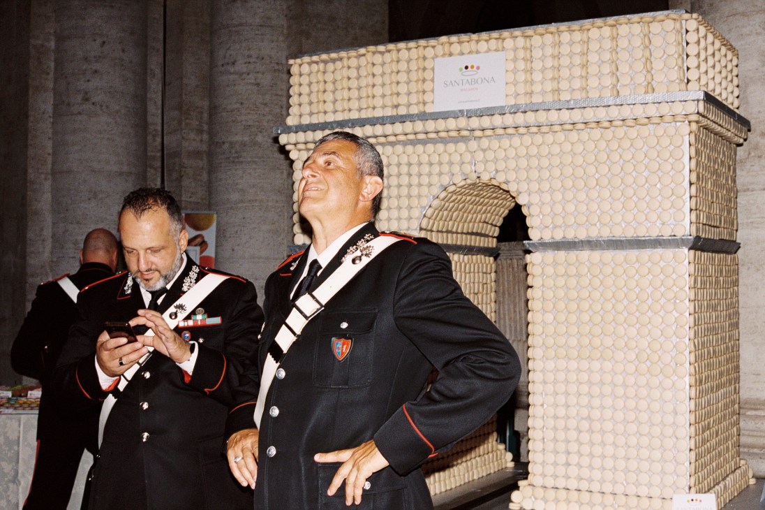 Military officials examine a decorative architectural element at Spain's National Mint facility.