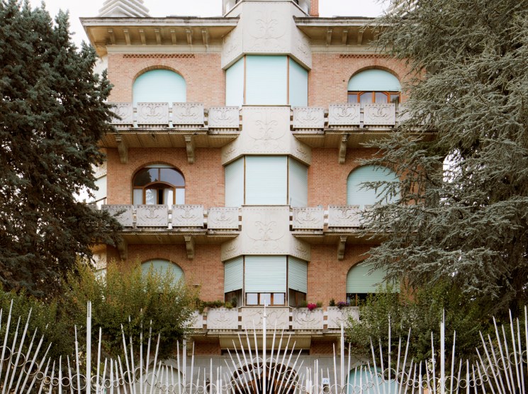 Condominio Manolino, a castle-like apartment building with turrets, balconies, and ornate white details