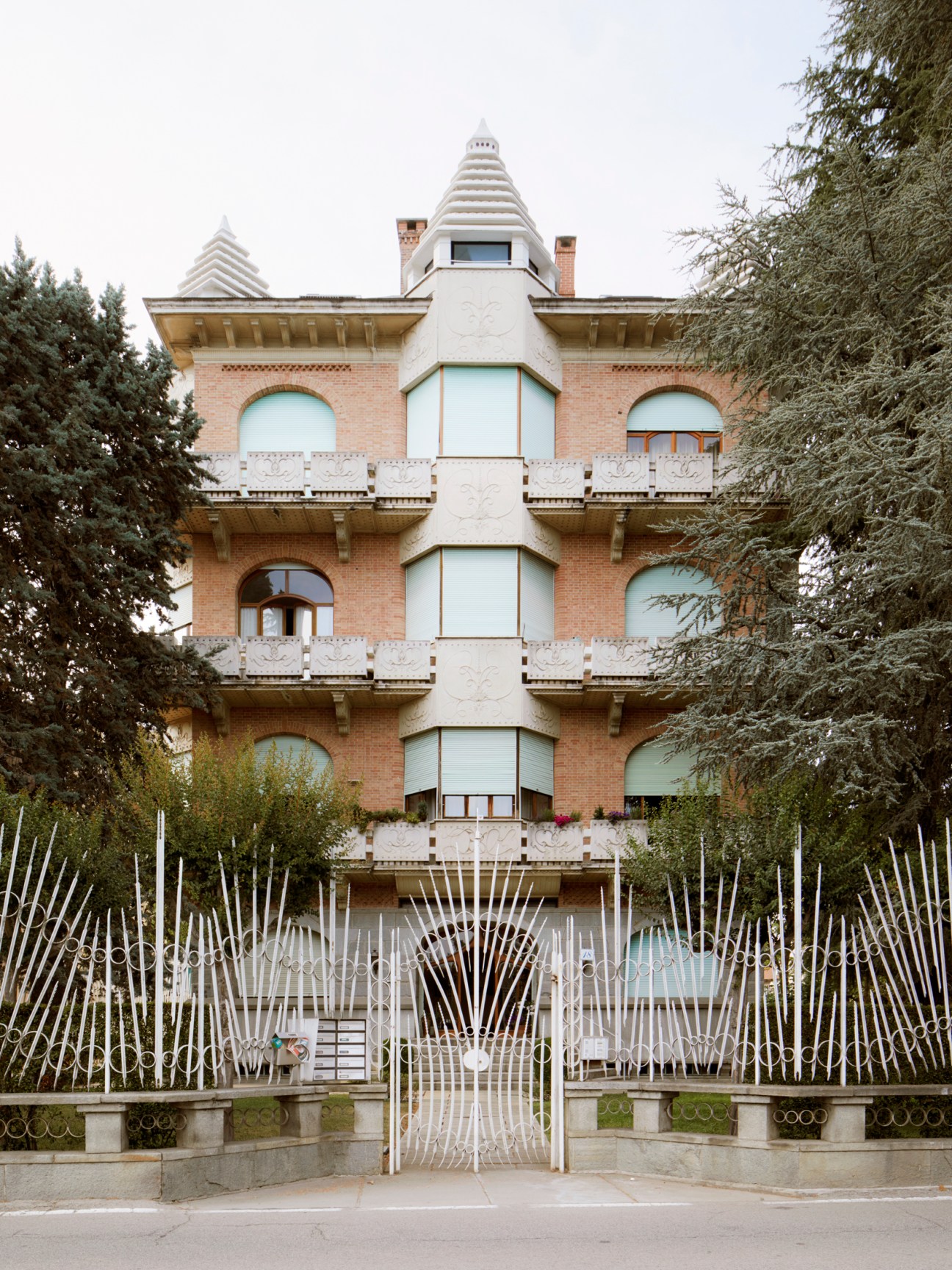 Condominio Manolino, a castle-like apartment building with turrets, balconies, and ornate white details