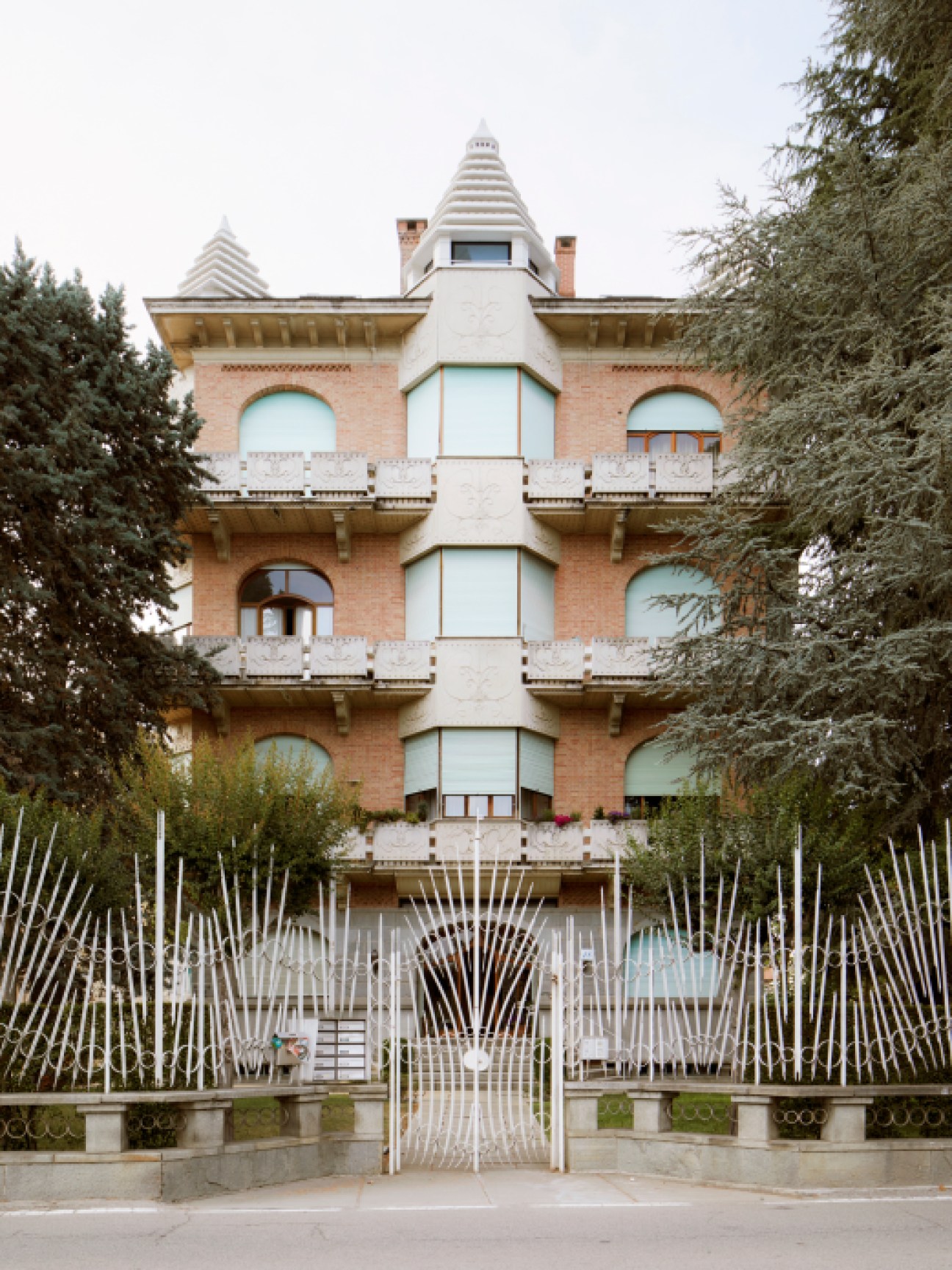Condominio Manolino, a castle-like apartment building with turrets, balconies, and ornate white details