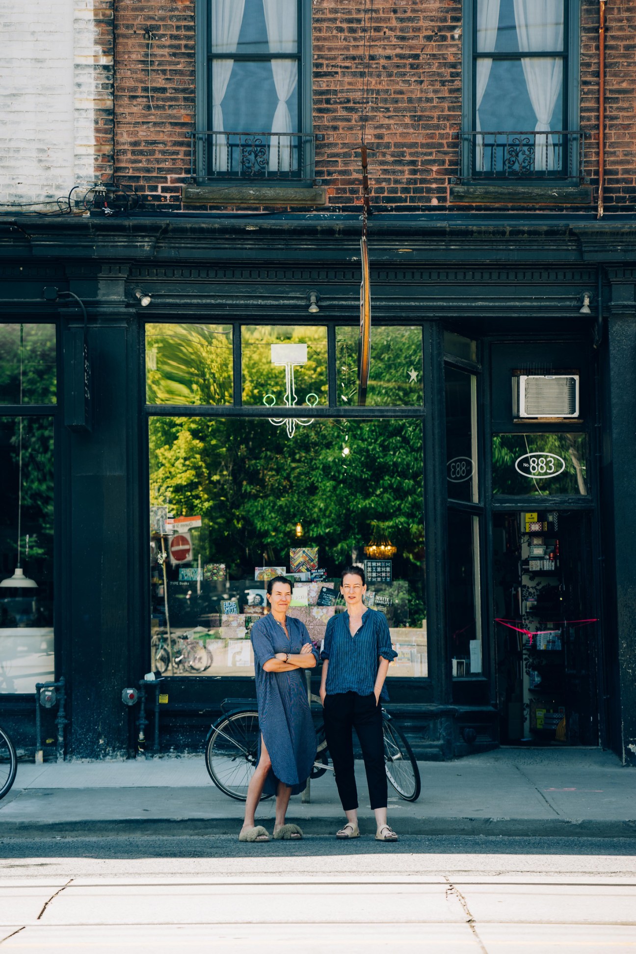 Type Books co-founders Jo Saul and Samara Walbohm standing outside their Toronto bookstore storefront