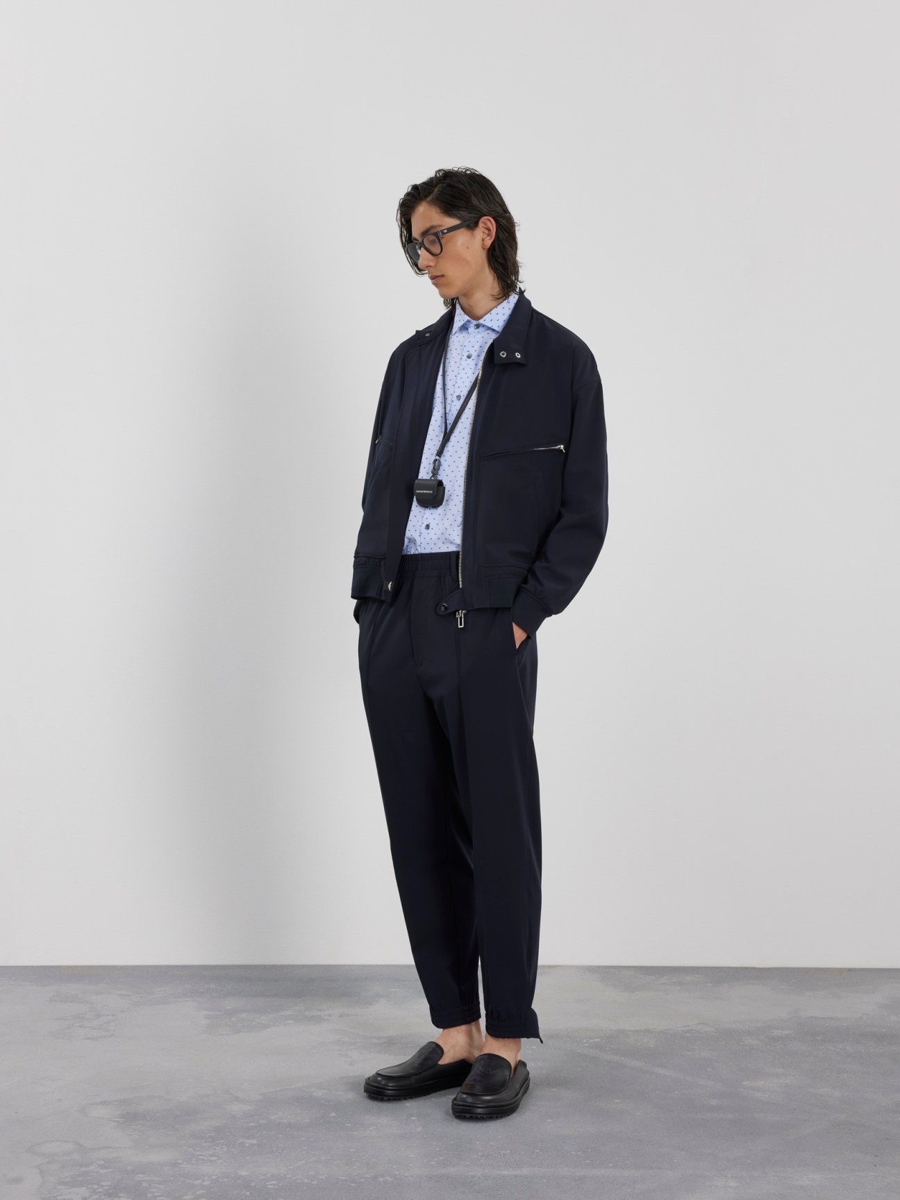 Woman wearing navy Emporio Armani Icons blazer and tailored trousers with light blue shirt