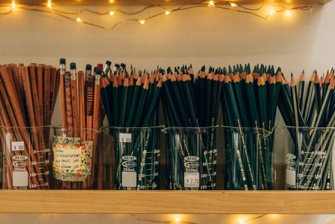 Glass jars filled with assorted pencils organized by type at Wonder Pens
