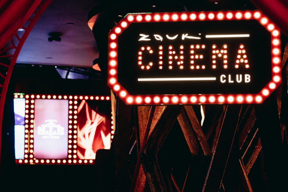 Illuminated Zouk Cinema Club sign with bright bulbs in vintage marquee style