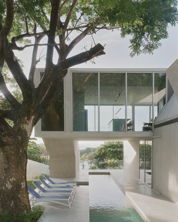 Interior view of Frame House showing cubic rooms with large windows and concrete walls