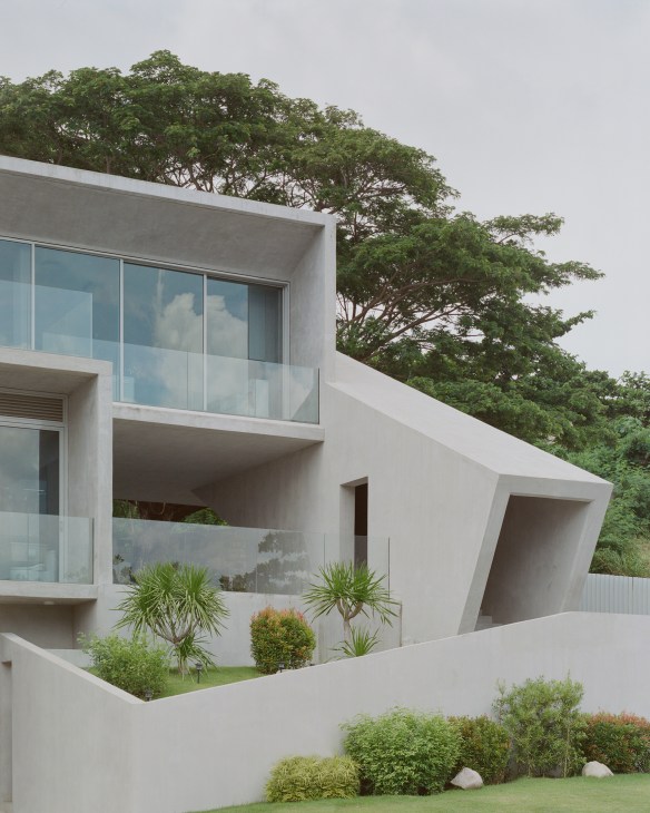 Modern concrete house with geometric frame structure overlooking the South China Sea