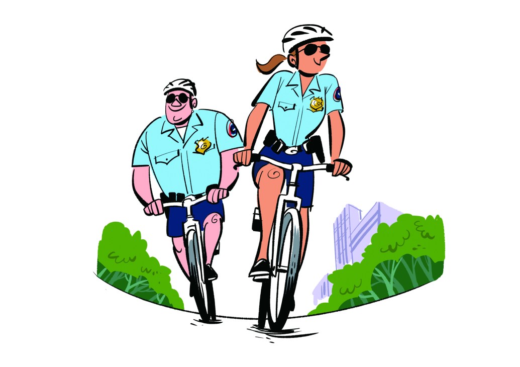 Police officers on bicycles interacting positively with citizens in a community setting