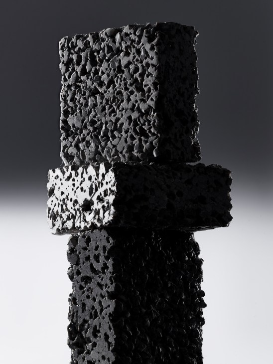 Stack of four EcoPact concrete blocks showing different textures and porosity levels