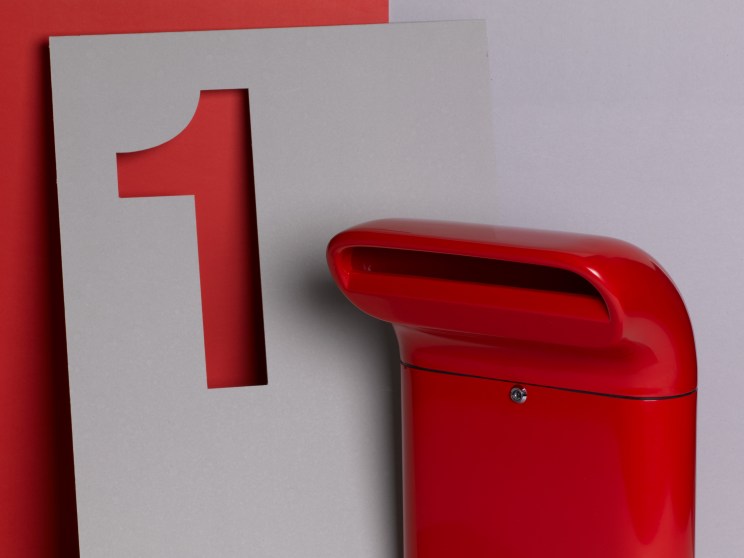 Red letter box with letter one on card nearby