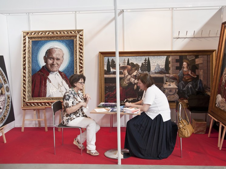 Sealing the deal at one of SacroExpo’s church- art stands