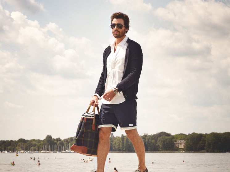 Cardigan by Bottega Veneta, shirt by Engineered Garments Intermediates, shorts by Saturdays, sunglasses by Gucci, shoes by Camper, bag by Ralph Lauren, watch by Rolex, ring model’s own