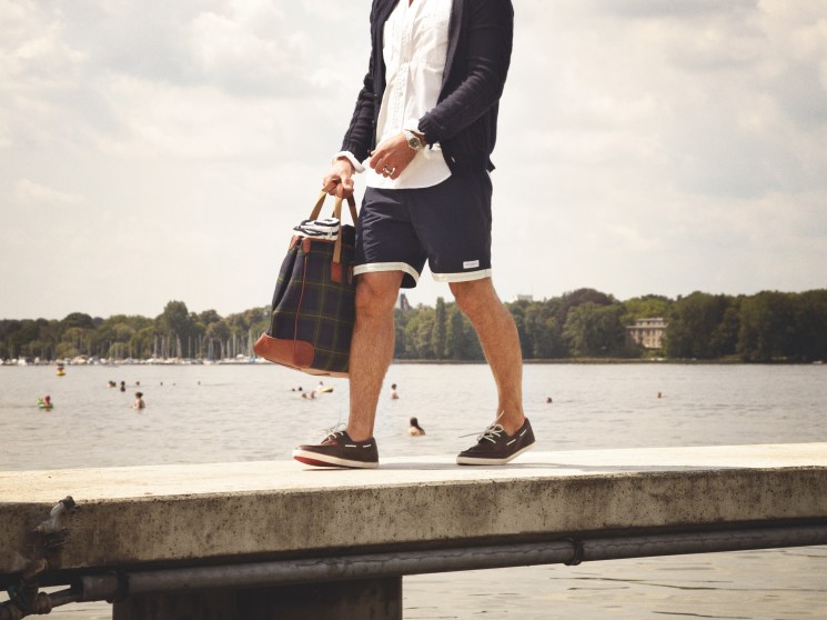 Cardigan by Bottega Veneta, shirt by Engineered Garments Intermediates, shorts by Saturdays, sunglasses by Gucci, shoes by Camper, bag by Ralph Lauren, watch by Rolex, ring model’s own
