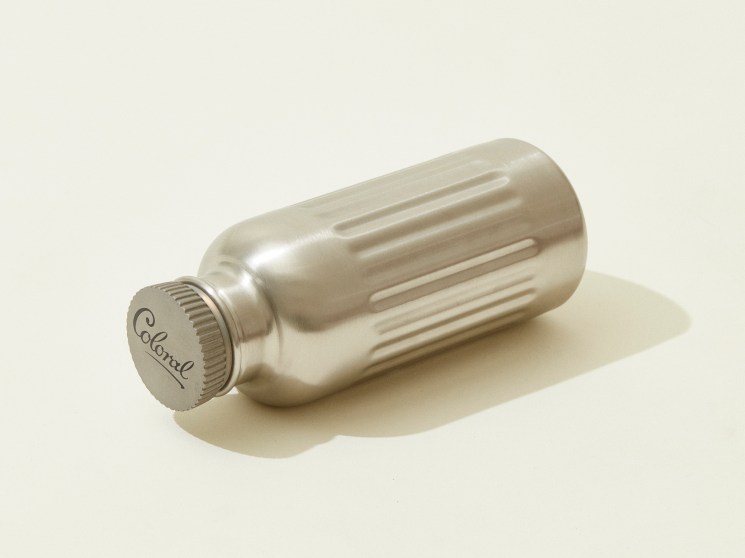 Brushed steel water bottle with ribbed texture and screw cap.