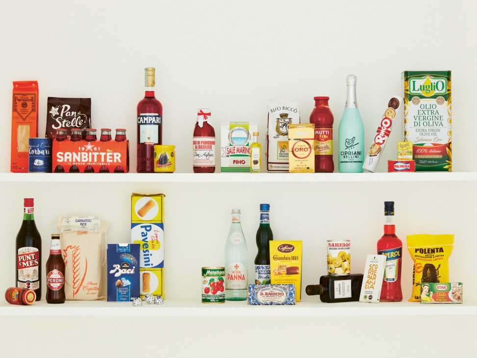 Two shelves displaying various Italian food and beverage products including pasta, wine, olive oil, and snacks