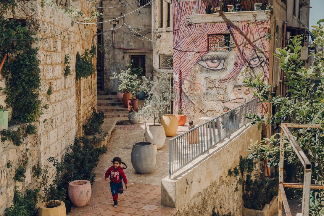 The transformed Chaarani Stairs in Tripoli showing colorful tile patterns and community use