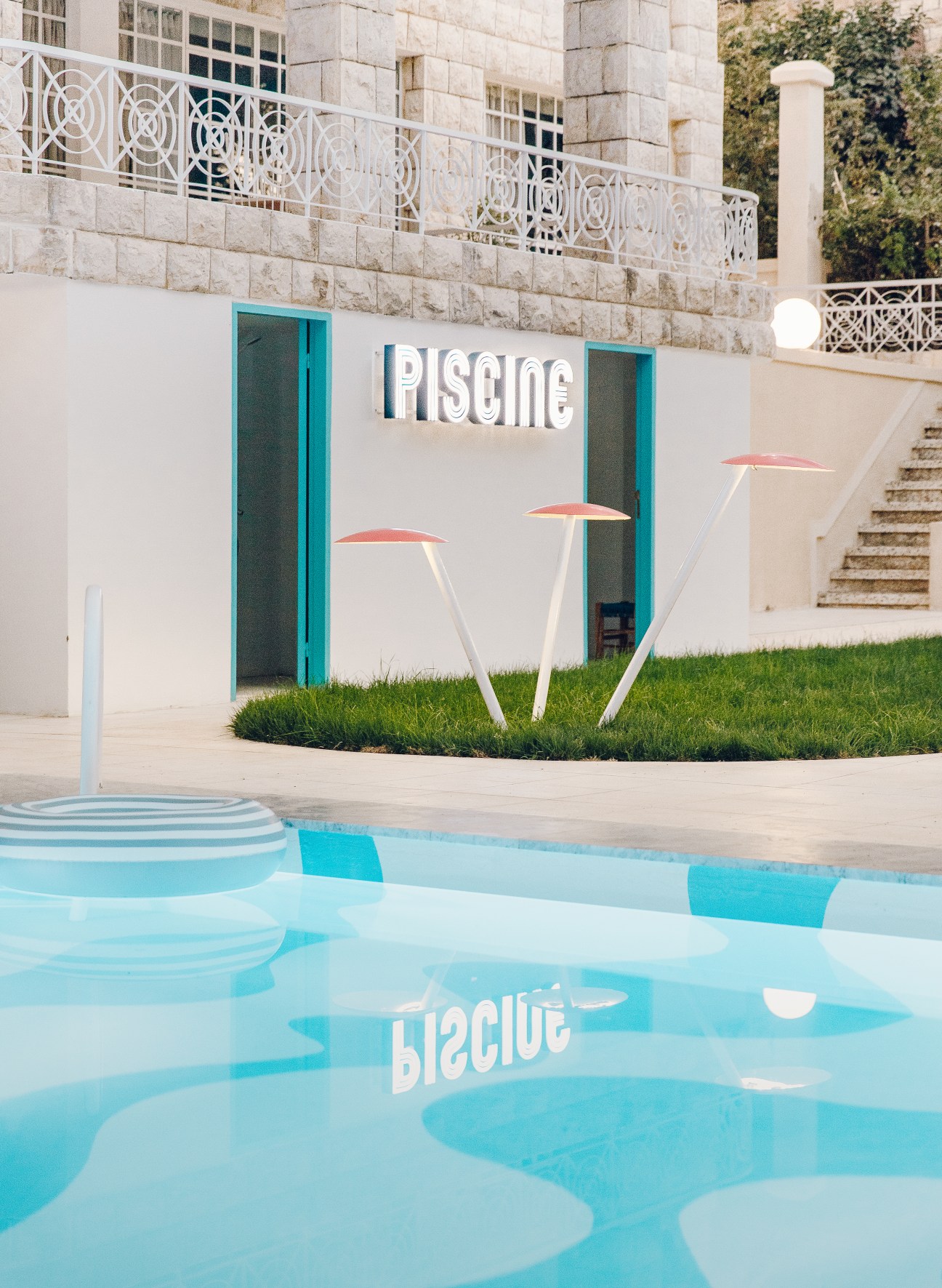 Op art pool with turquoise and white geometric patterns designed by Rana Salam at Villa Chamoun hotel