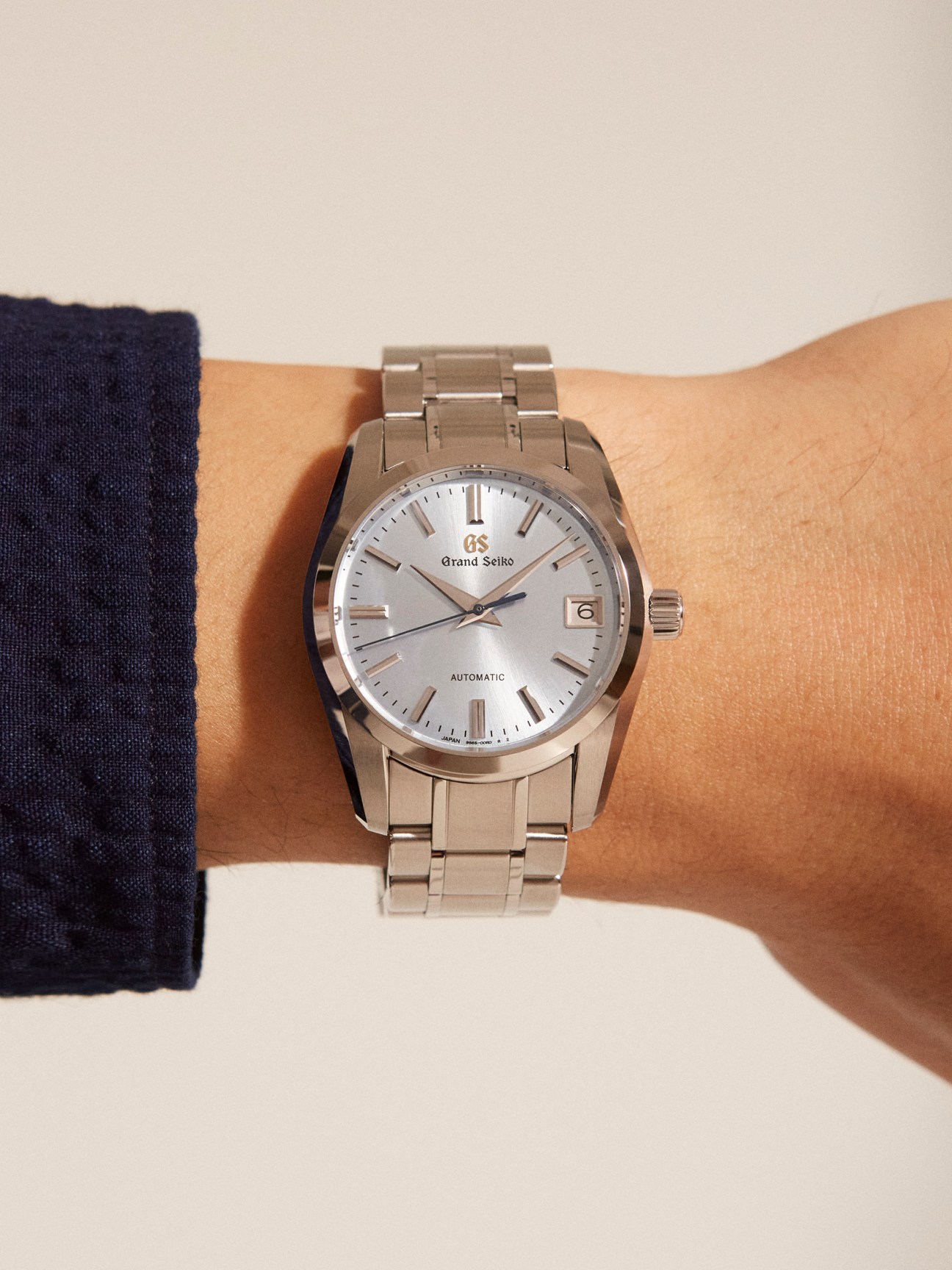 Grand Seiko Chuten Mid-Heaven automatic watch with silver dial on stainless steel bracelet worn on wrist.