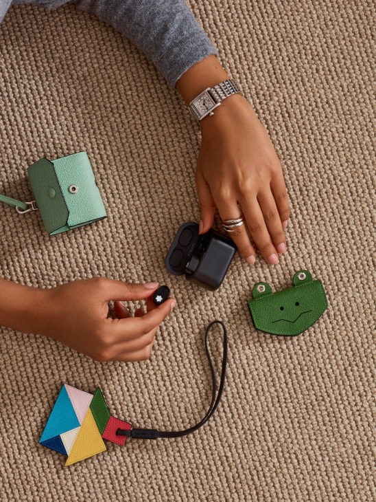 Colorful luxury accessories including polo shirt, watch, jewelry, tech accessories and headphones for modern lifestyle