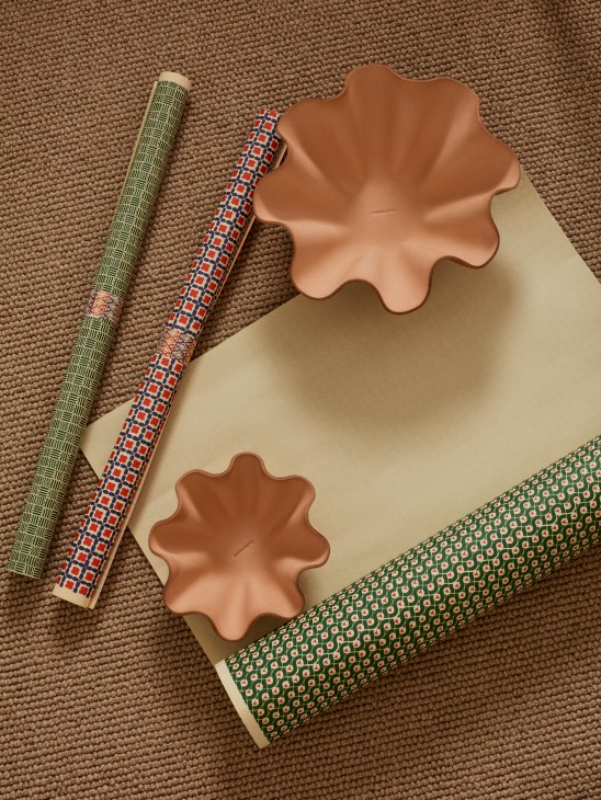 Elegant shell bowls with gift wrapping papers showing luxury home accessories and packaging
