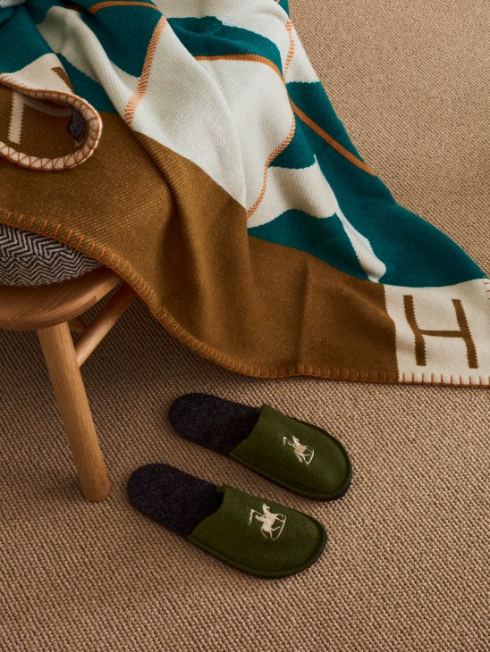 Luxury blanket and slippers arranged for comfortable home styling and gifting