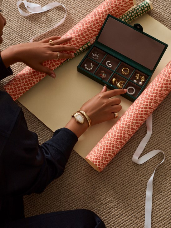 Luxury jewelry display with watch, rings, jewelry box and elegant gift wrapping materials