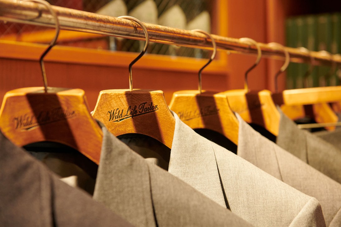 Wild Life Tailor shop interior with suits hanging on wooden hangers and clothing displays