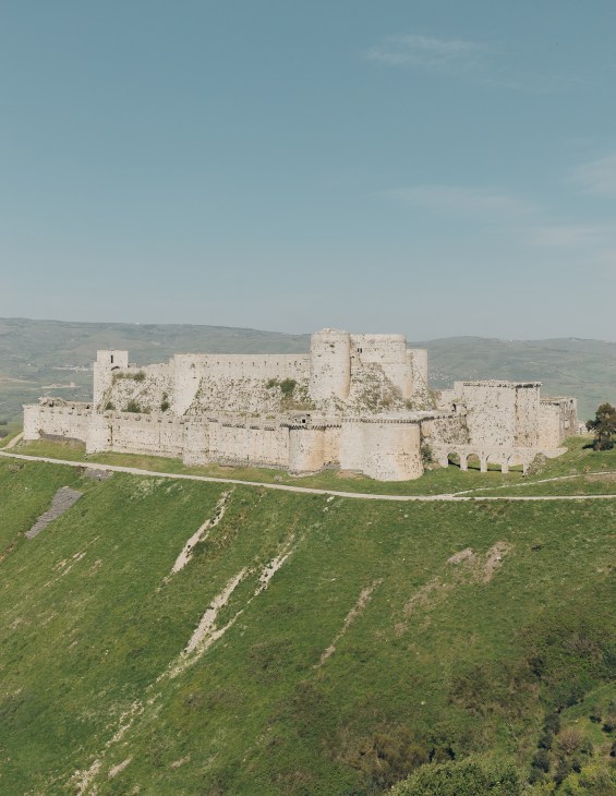 Medieval Krak des Chevaliers castle fortress situated on a hilltop with stone walls and towers