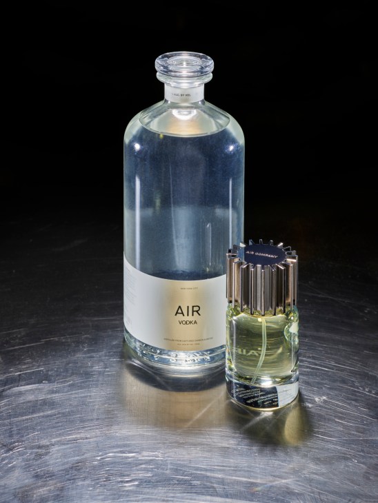 Air Company vodka bottle and fragrance displayed on wooden surface
