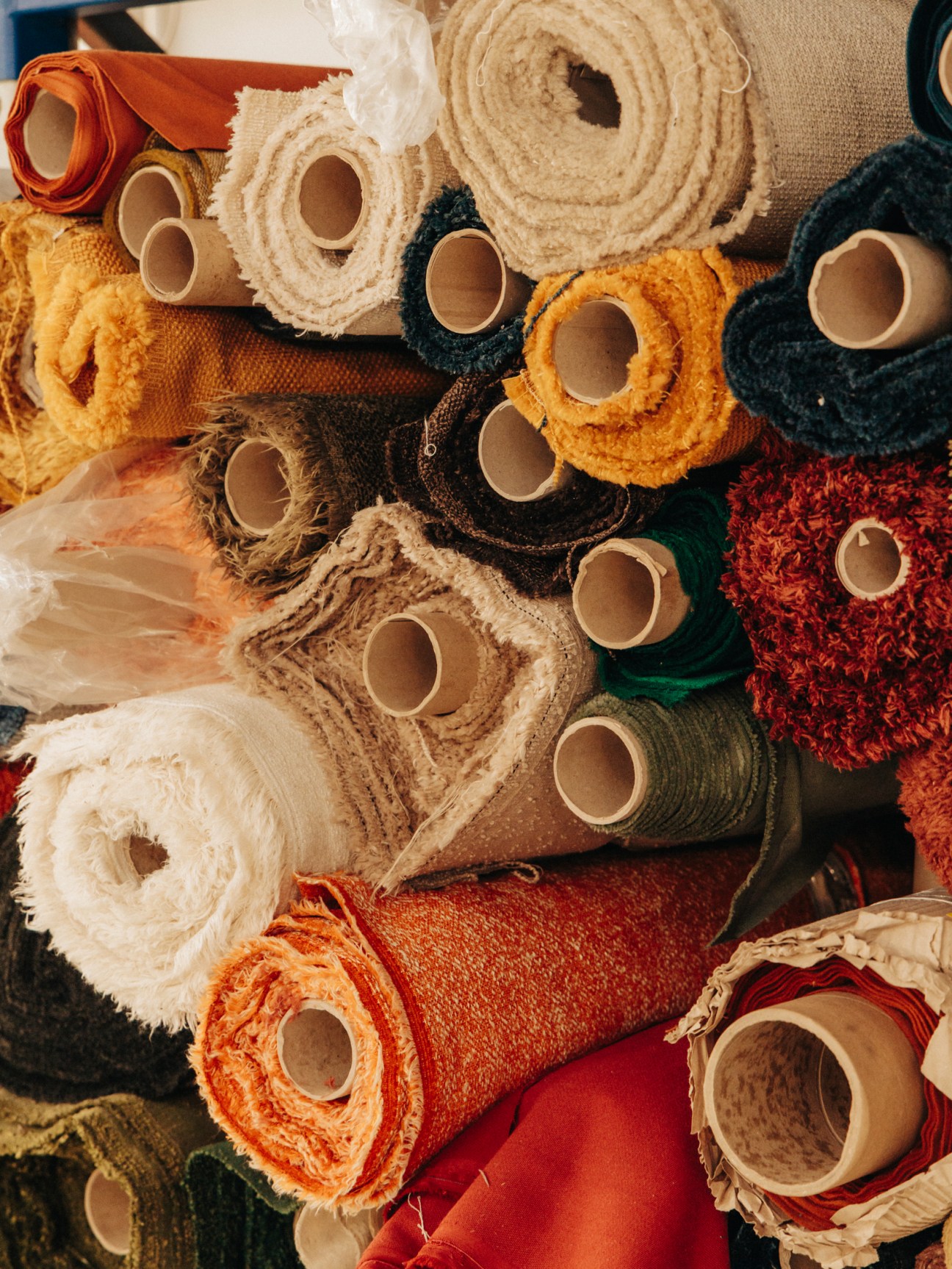 Rolls of colorful textile fabrics at Claudie Design factory