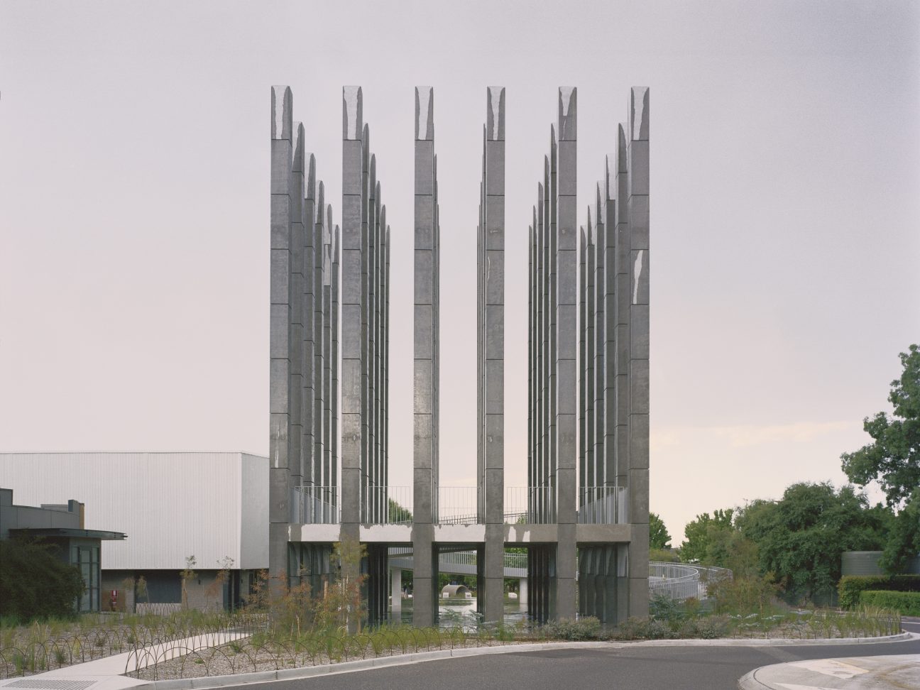 Brutalist concrete column structure with 36 tall vertical pillars arranged in symmetrical grid at Canberra's Dairy Road, designed by Pezo von Ellrichshausen