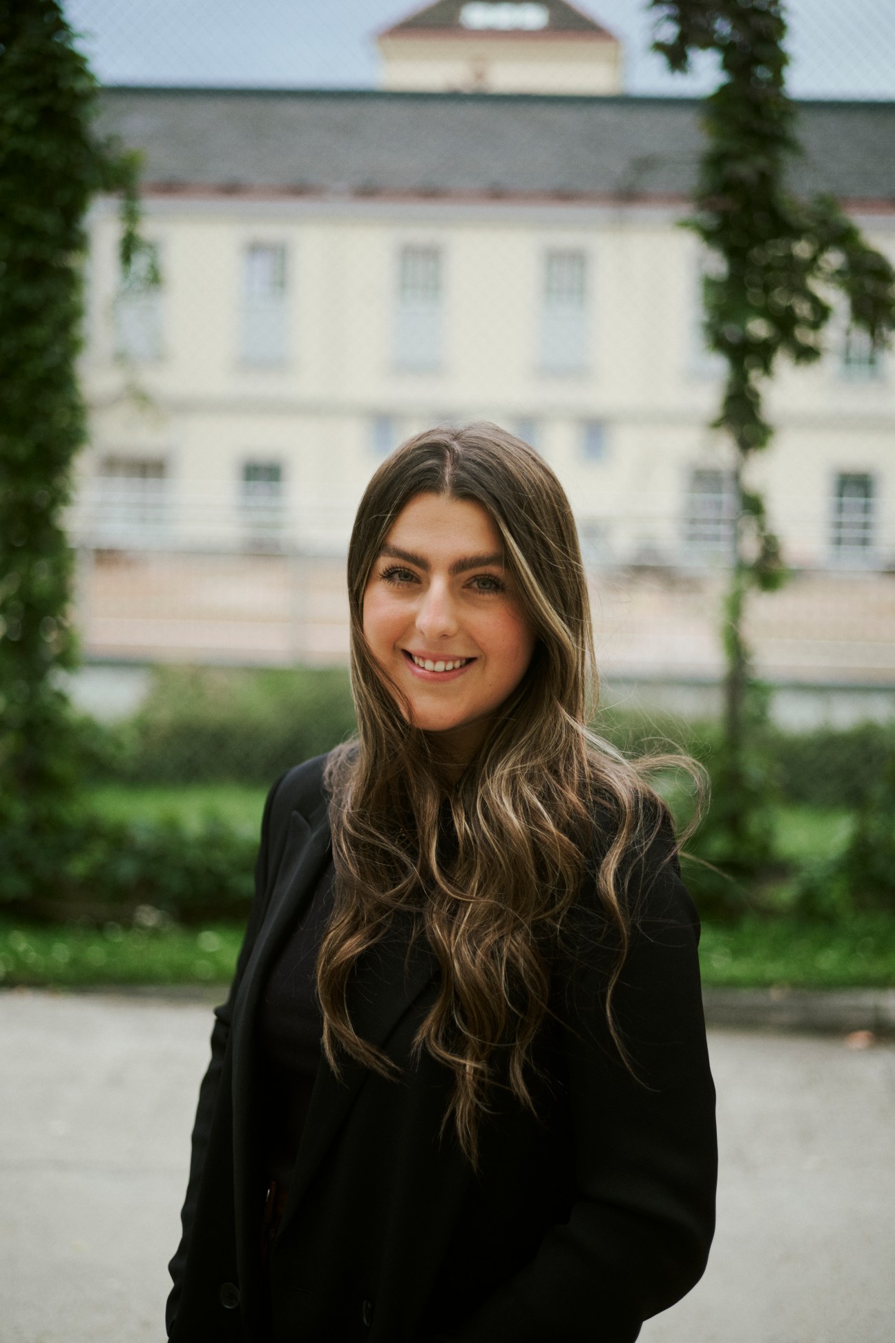 Portrait of Ava Melenchuk, a Canadian student, seated in the academy building