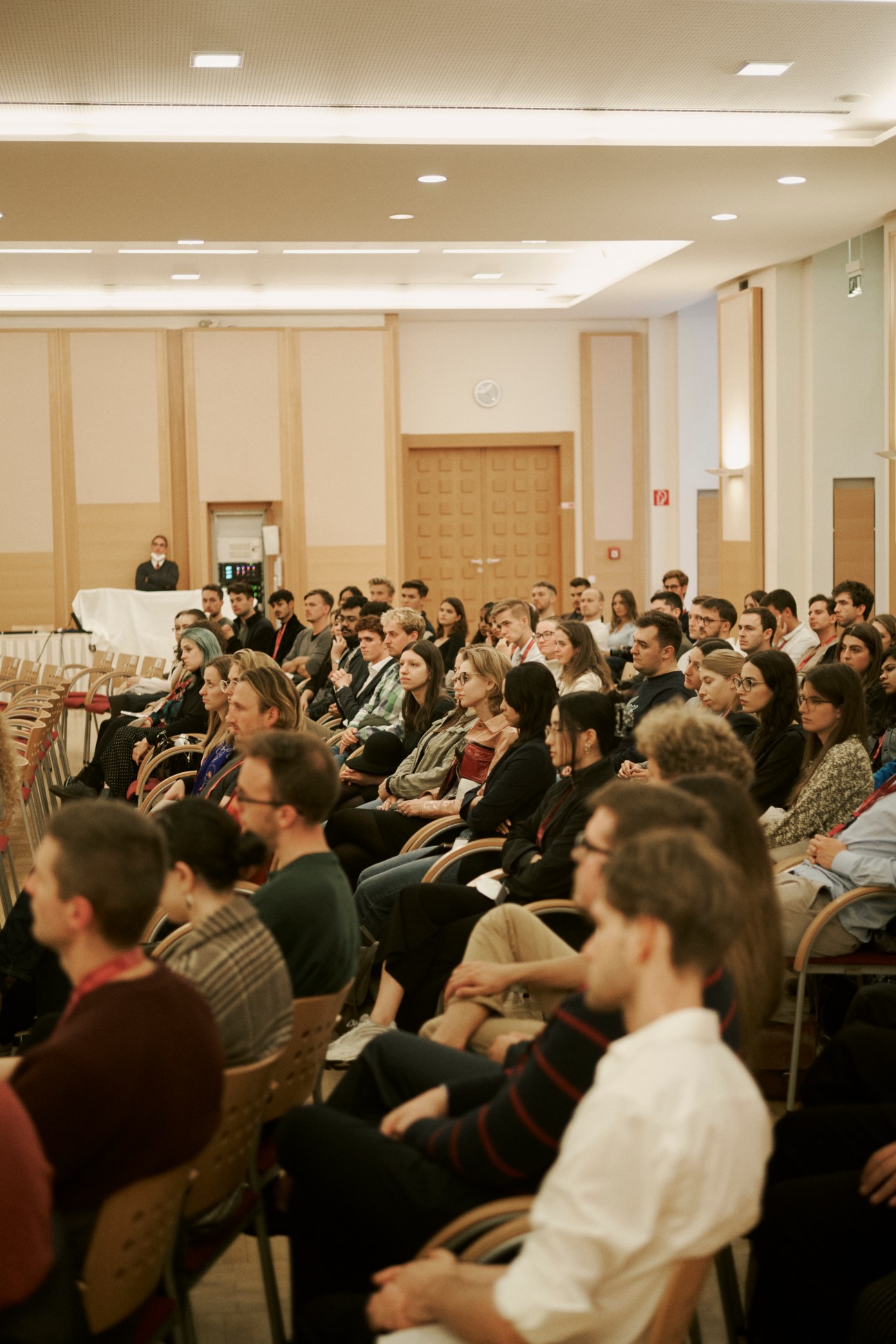 Students seated in rows listening to a lecture in the main hall of the Vienna School of International Studies