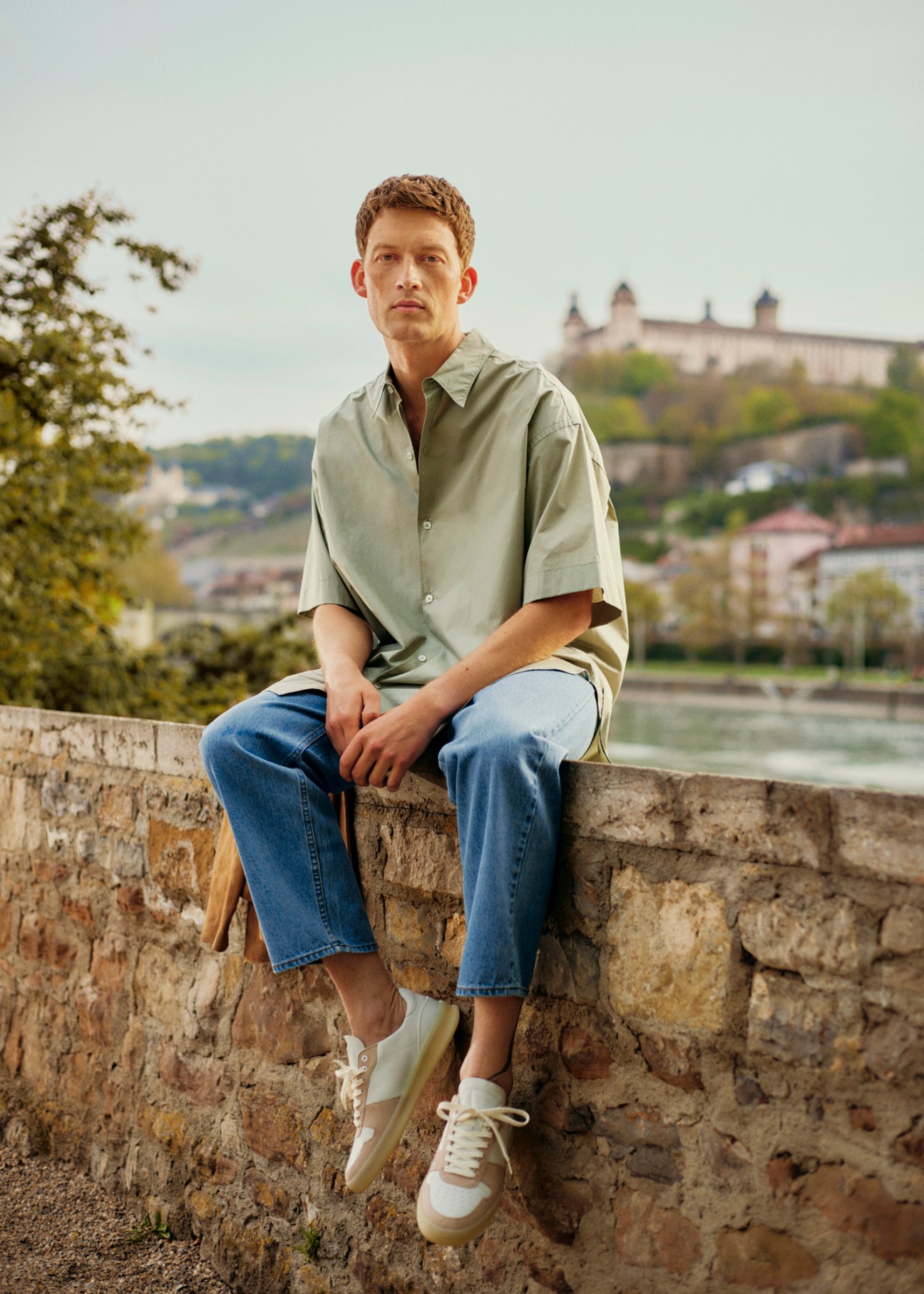 Model in casual shirt and jeans with trainers