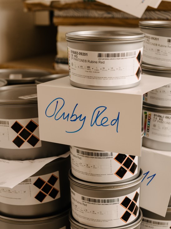 Close-up view of printing ink containers and tools used in the book production process