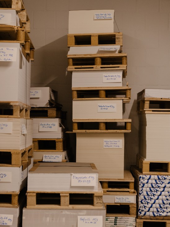 Paper storage warehouse showing stacks of paper stored in controlled environmental conditions