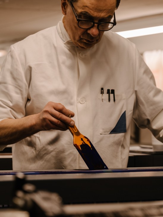 Steidl testing the consistency and flow of printing ink as part of his quality control process