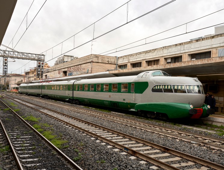 The distinctive aerodynamic nose of the ETR 252 L'Arlecchino train at Rome Ostiense station platform