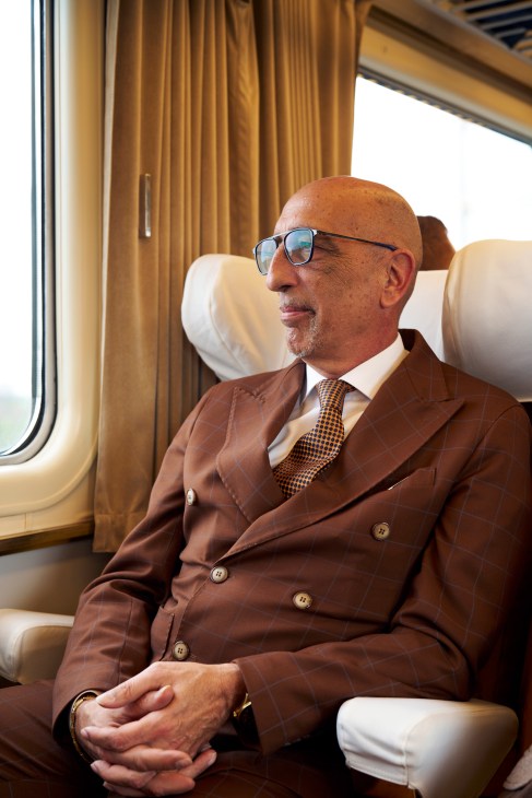 Passengers relaxing in period train seats with vintage upholstery