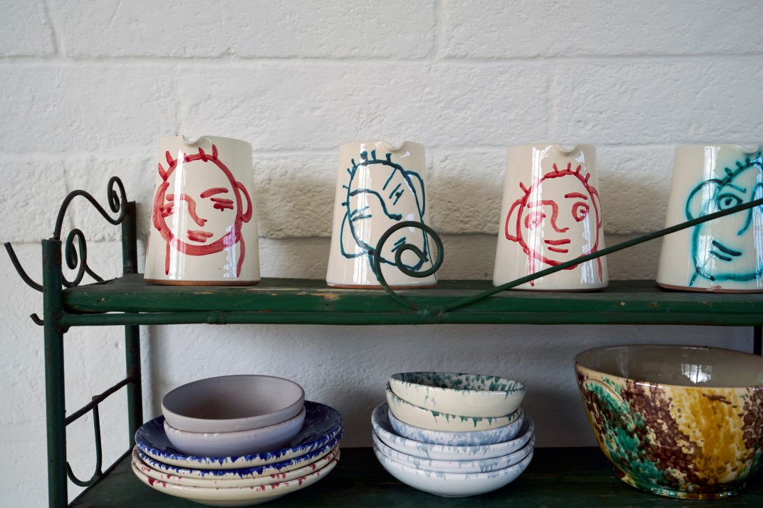 Handcrafted ceramic plates and bowls with distinctive glaze patterns
