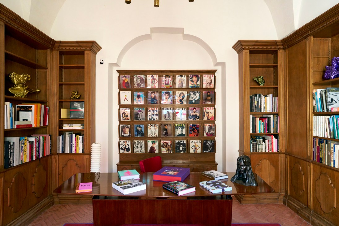 Elegant library room with bookshelves, modern furniture and curated design objects at Palazzo Luce